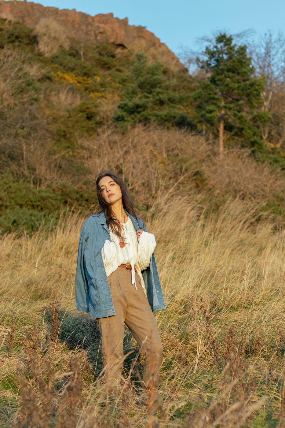 Standing in tall autumn grass in a denim jacket